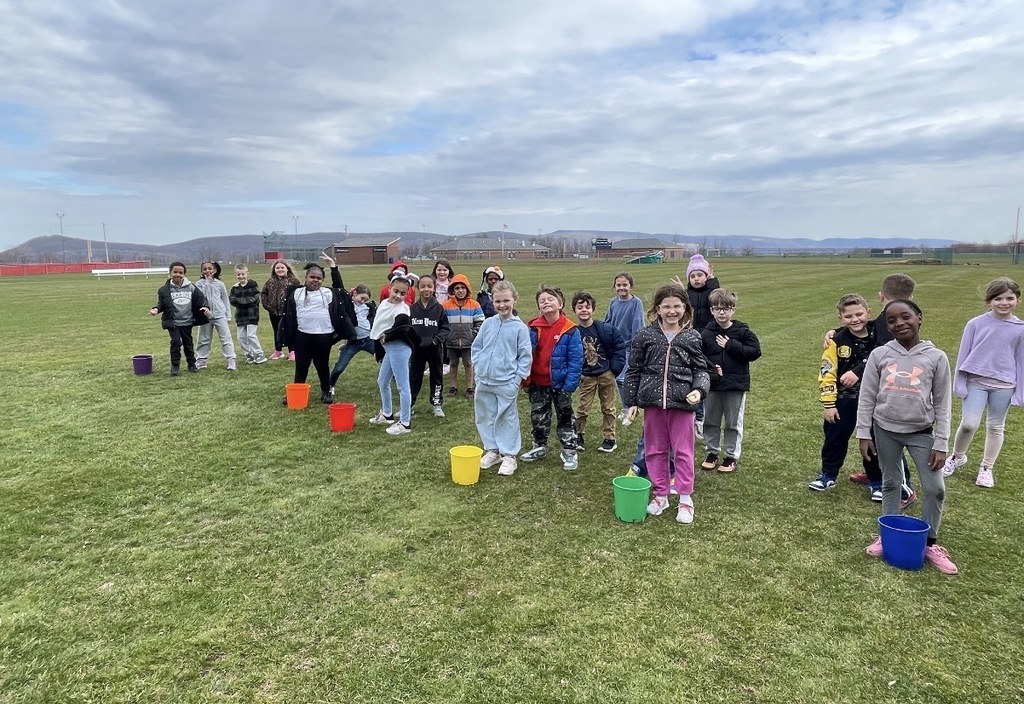 A group of students in a field outside of the school.  