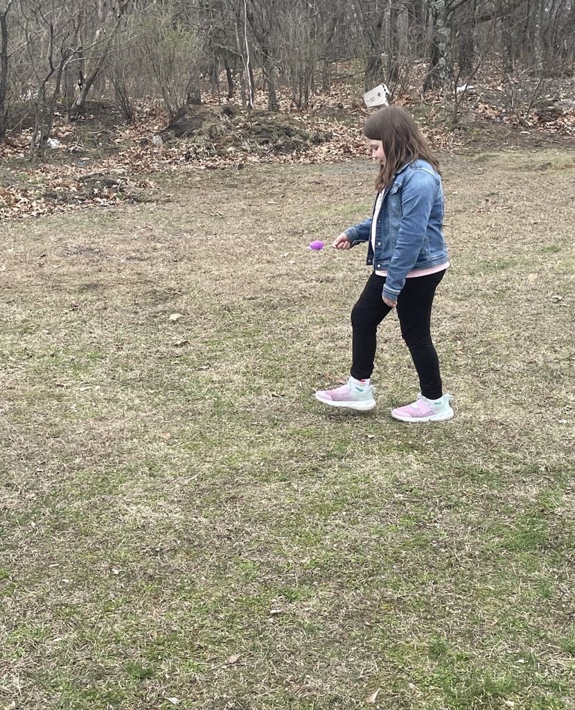 A student with a egg on a spoon. 