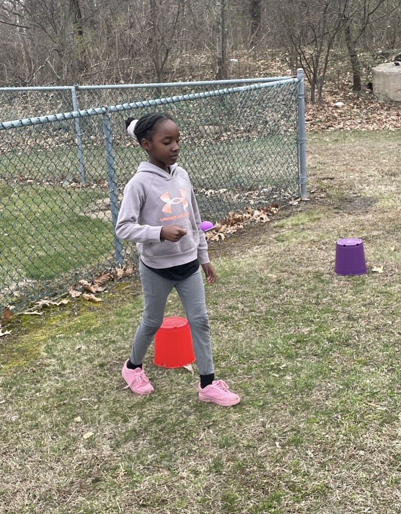 A student with a egg on a spoon. 