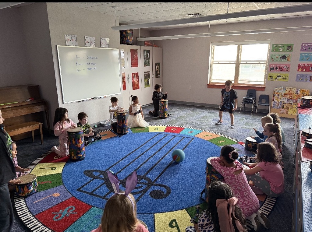 Students seated in a dark classroom. 