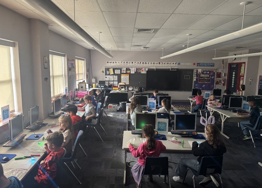 Students seated in a dark classroom. 