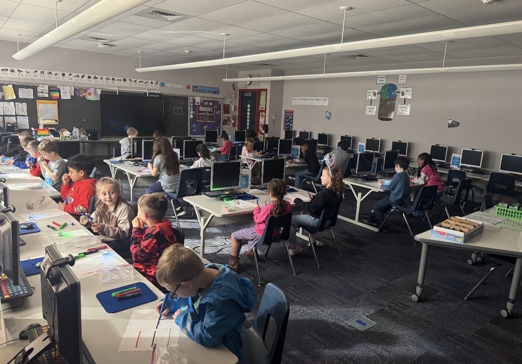 Students seated in a dark classroom. 
