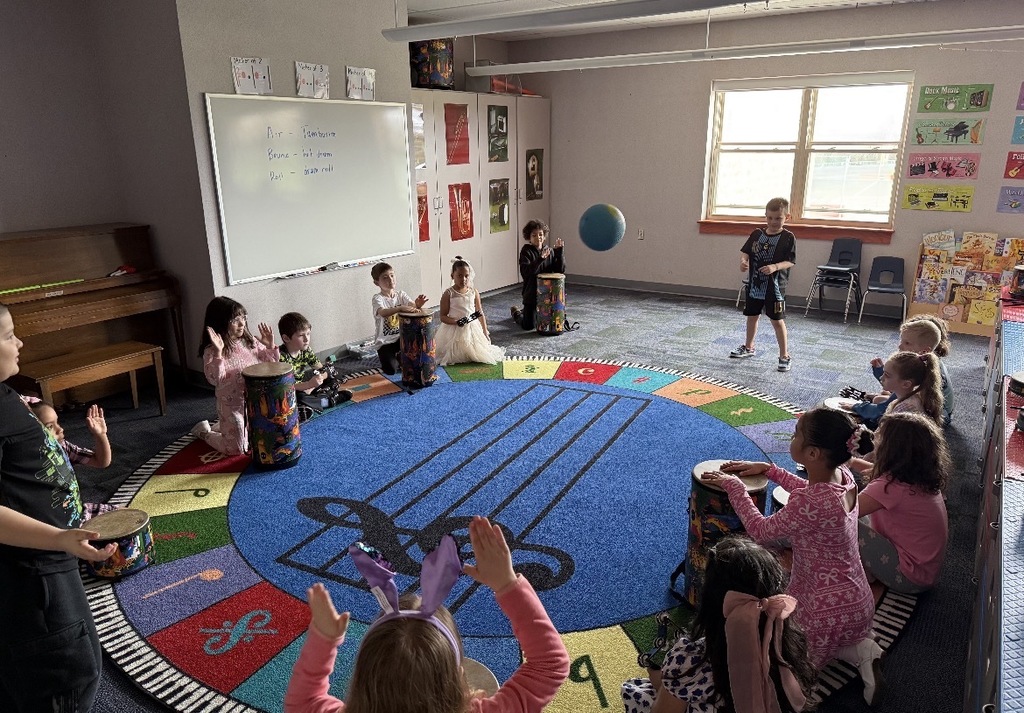 Students seated in a dark classroom. 