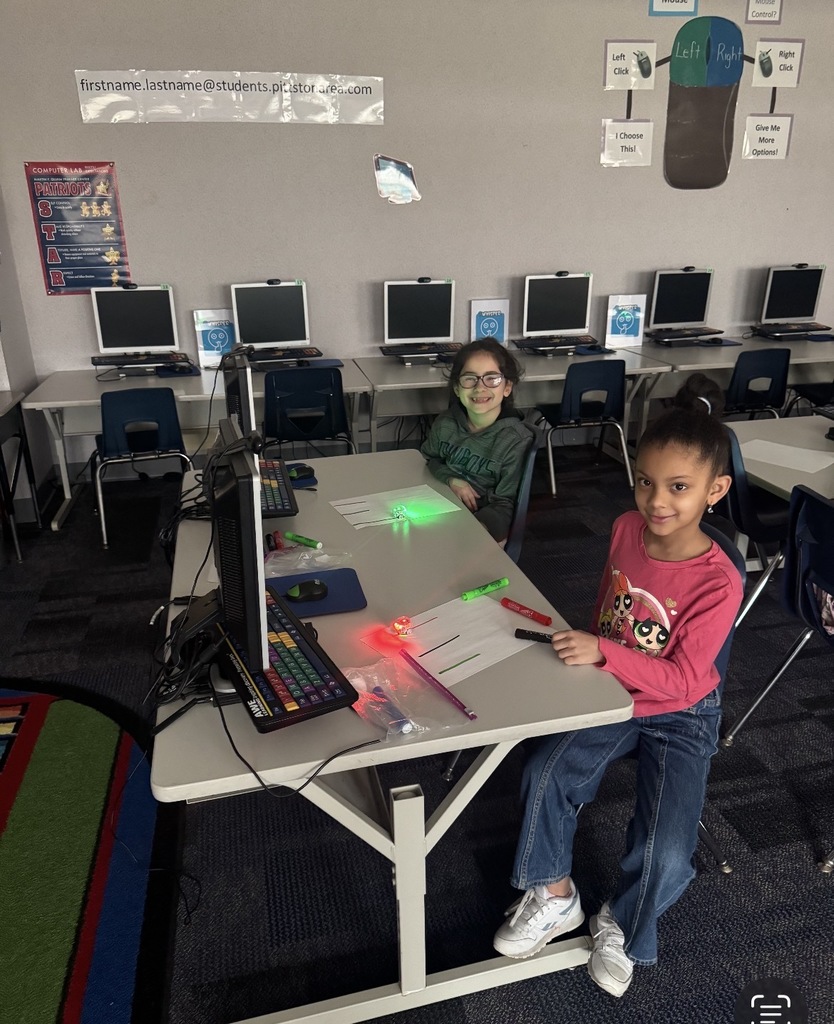 Students seated in a dark classroom. 