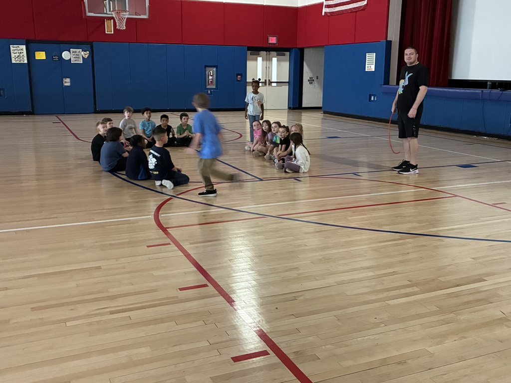 Students seated in a dark classroom. 