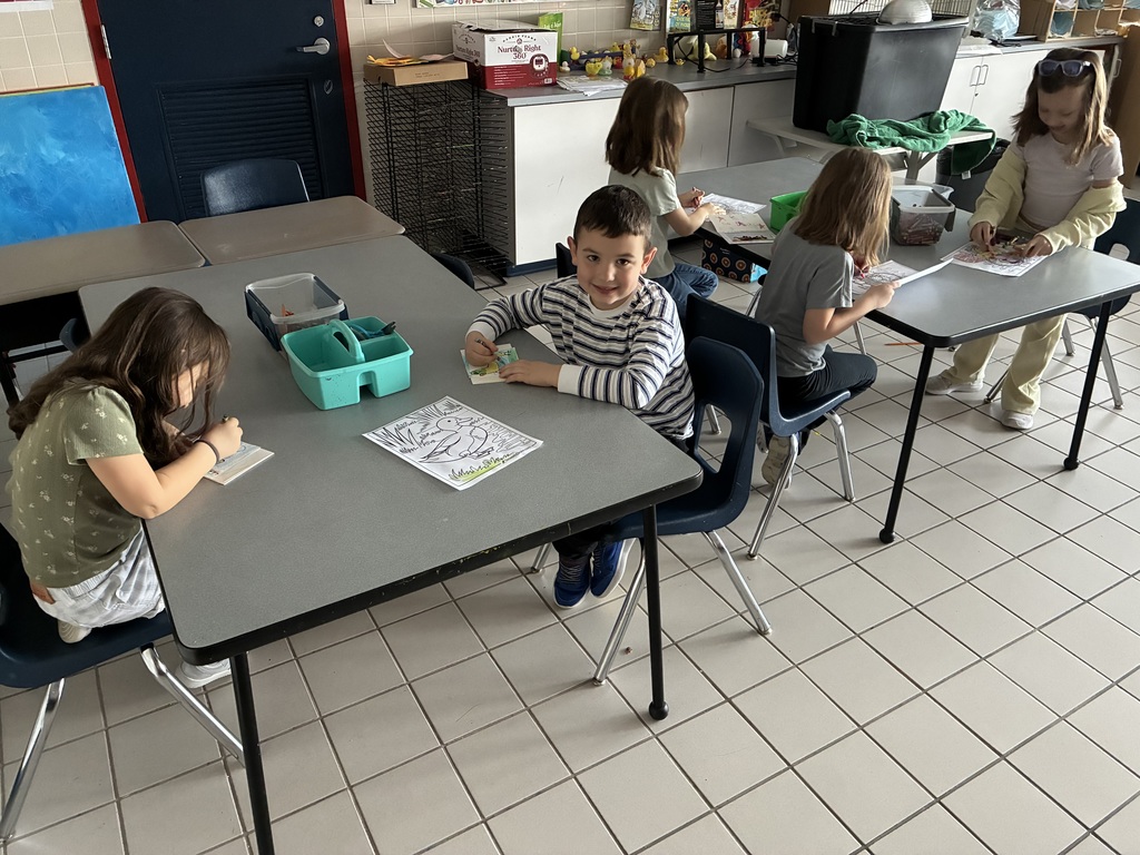 Students seated in a dark classroom. 