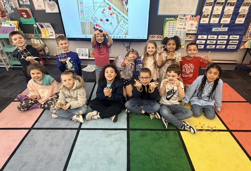 Students in a group holding jelly bean structures 