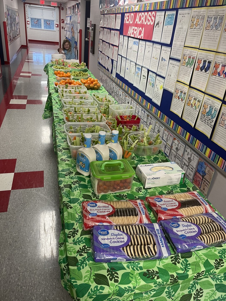 An assortment of snacks on a green table cloth.