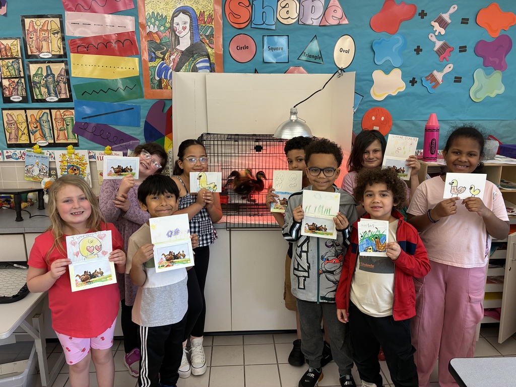Kids holding pictures with ducks 
