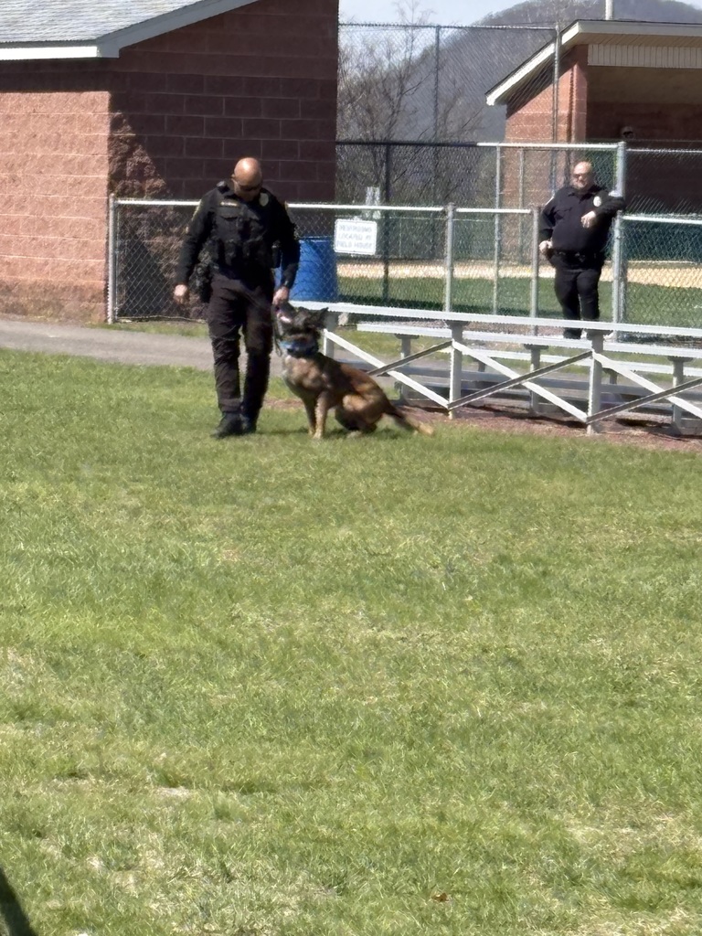 A police officer outside with a police dog