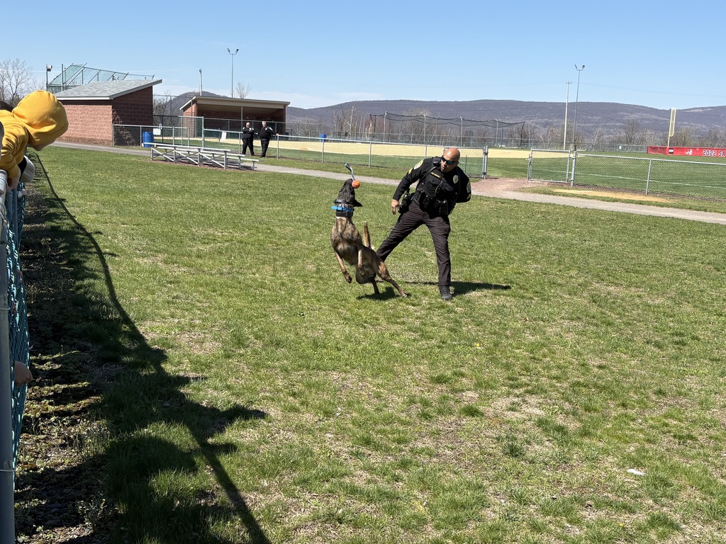 A police officer outside with a police dog