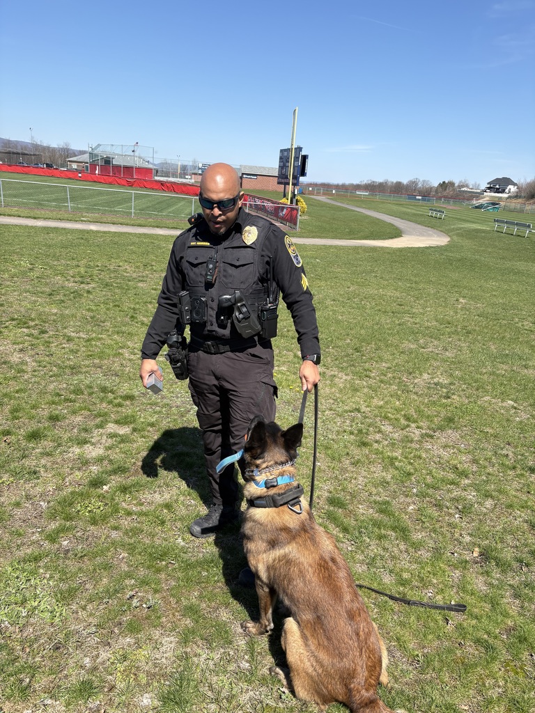 A police officer outside with a police dog