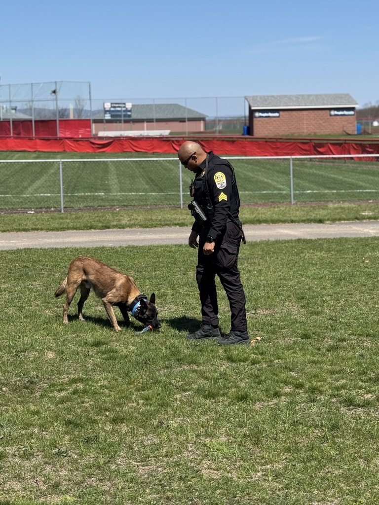 A police officer outside with a police dog