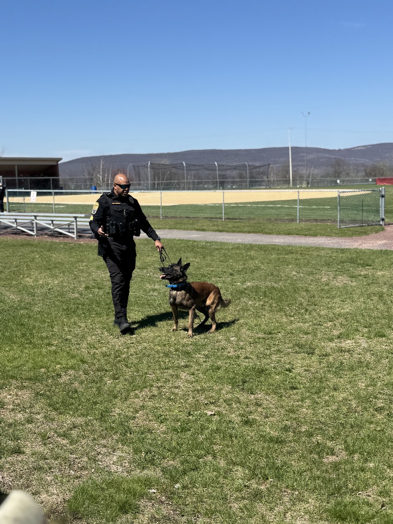 A police officer outside with a police dog