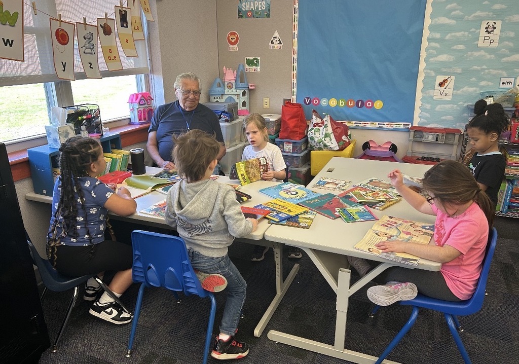Students working with literacy materials in a kindergarten classroom. 