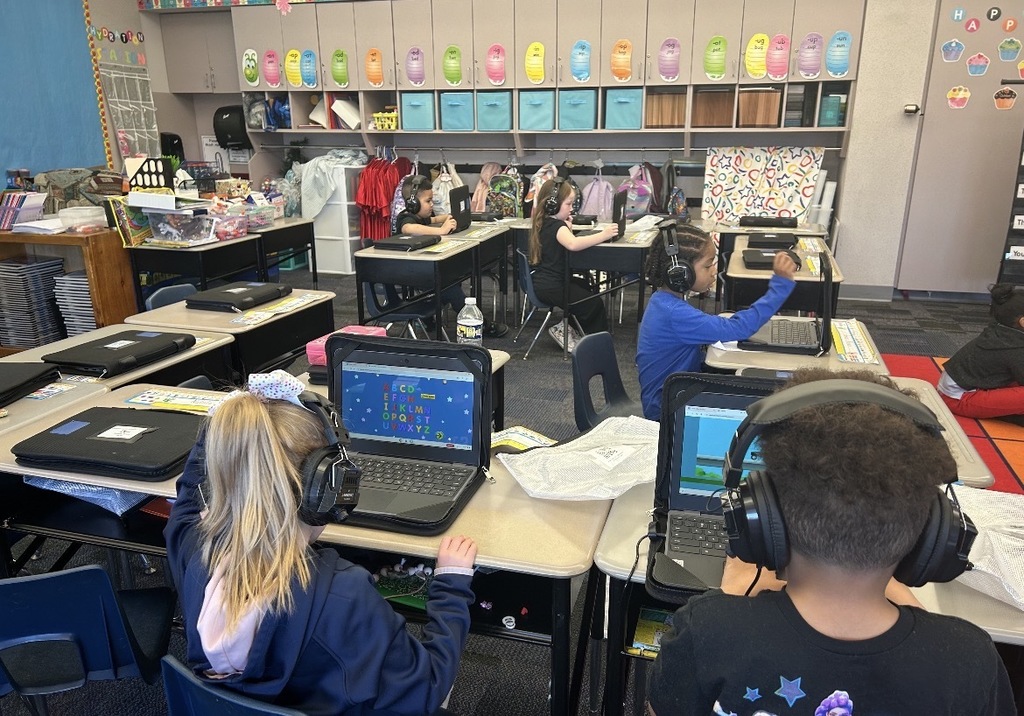 Students working with literacy materials in a kindergarten classroom. 