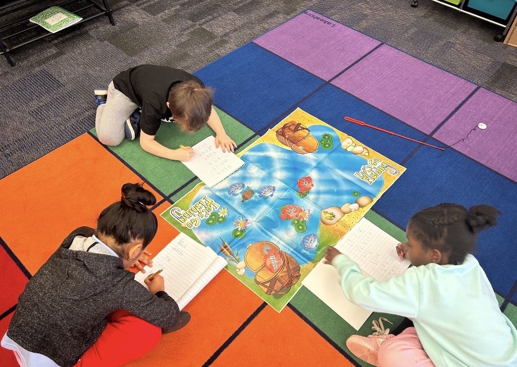 Students working with literacy materials in a kindergarten classroom. 