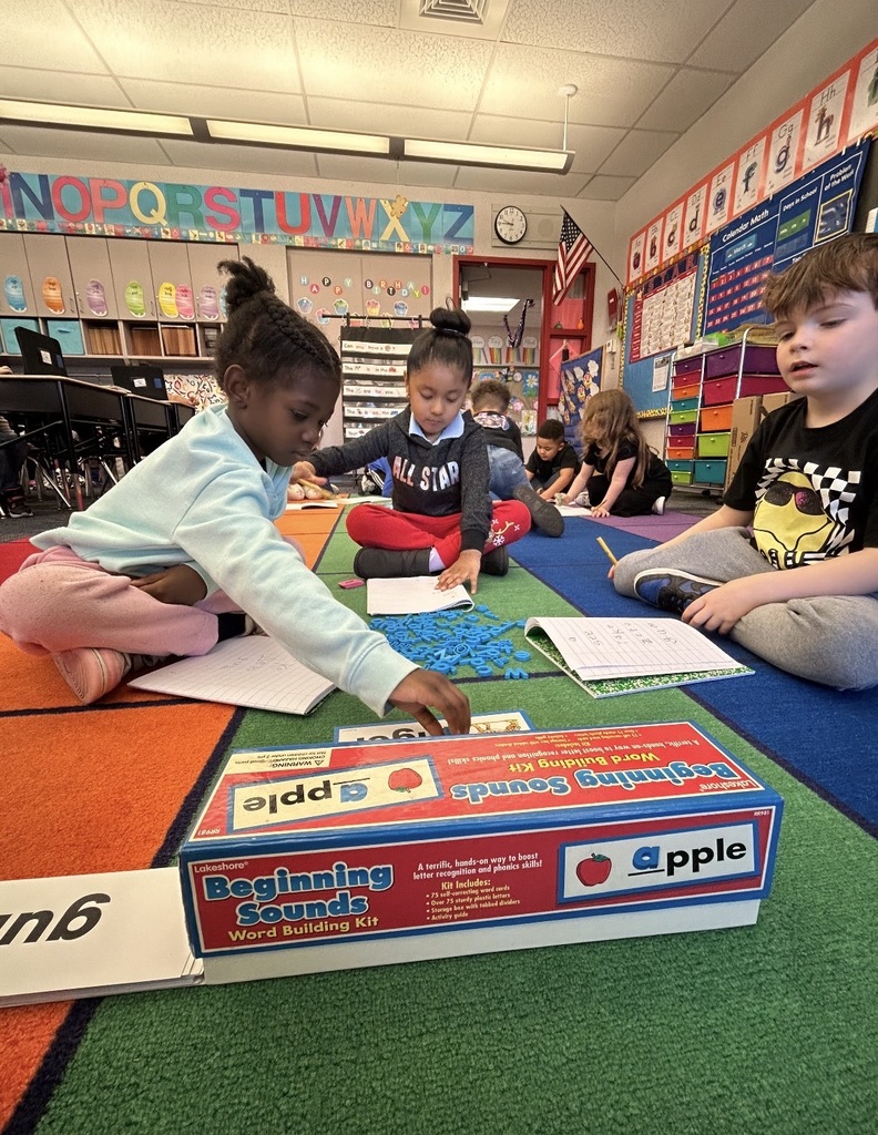 Students working with literacy materials in a kindergarten classroom. 