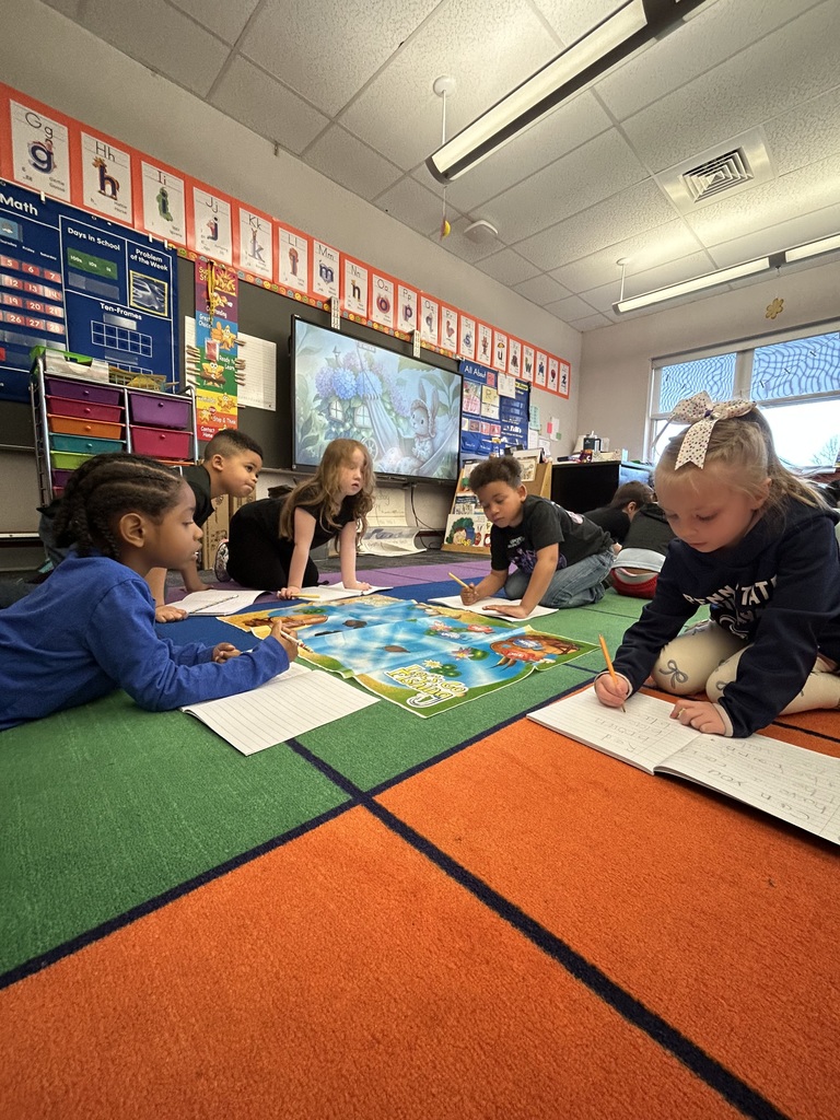 Students working with literacy materials in a kindergarten classroom. 