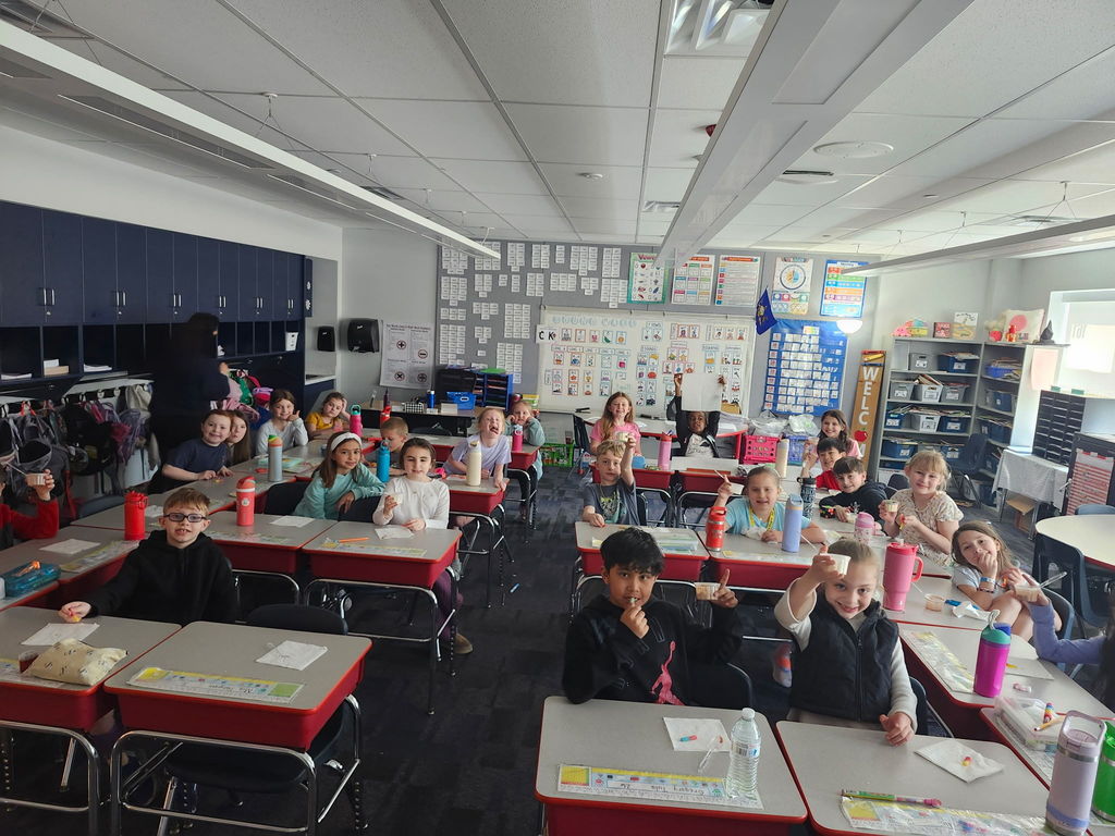 Students eating in  a classroom. 