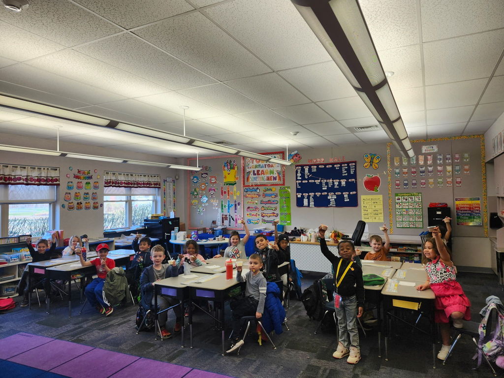 Students eating in  a classroom. 