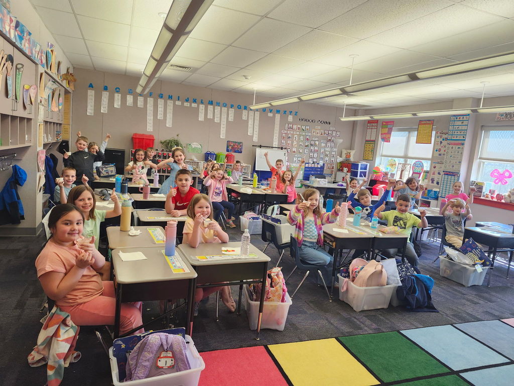 Students eating in  a classroom. 