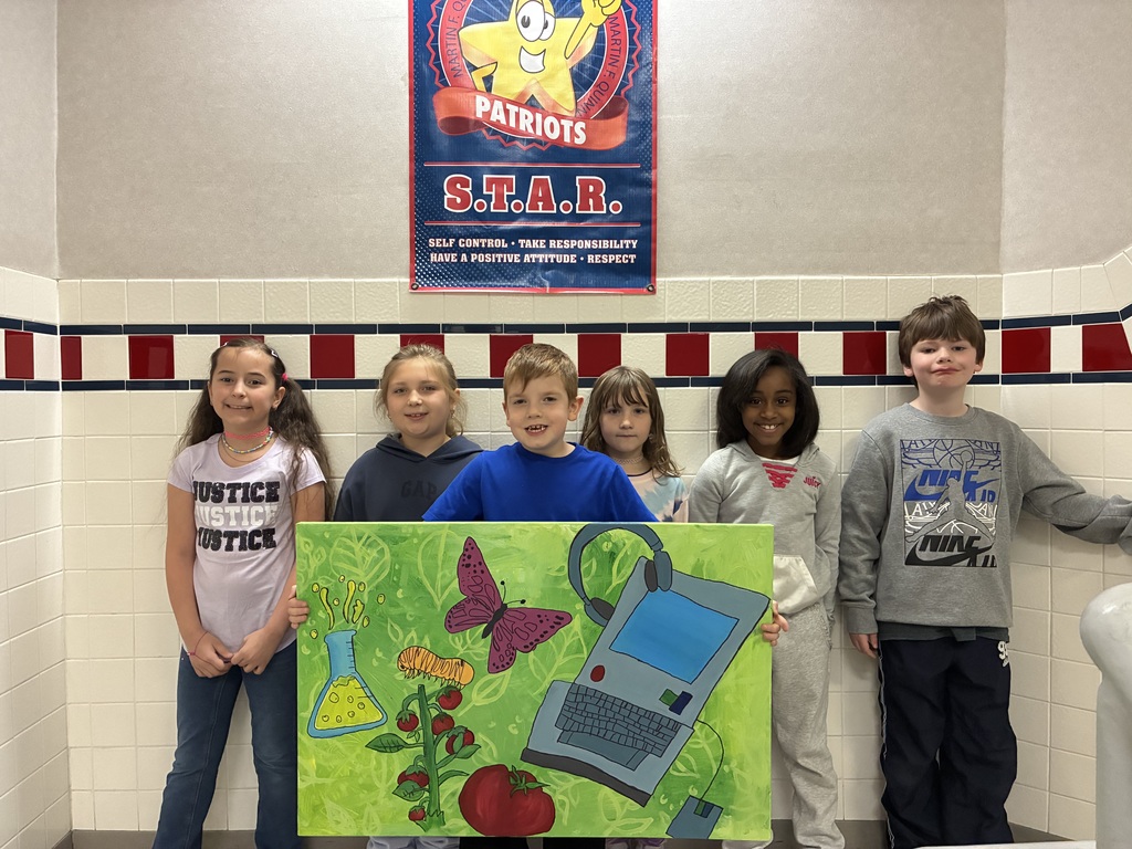 A group of students holding a canvas with school themed items