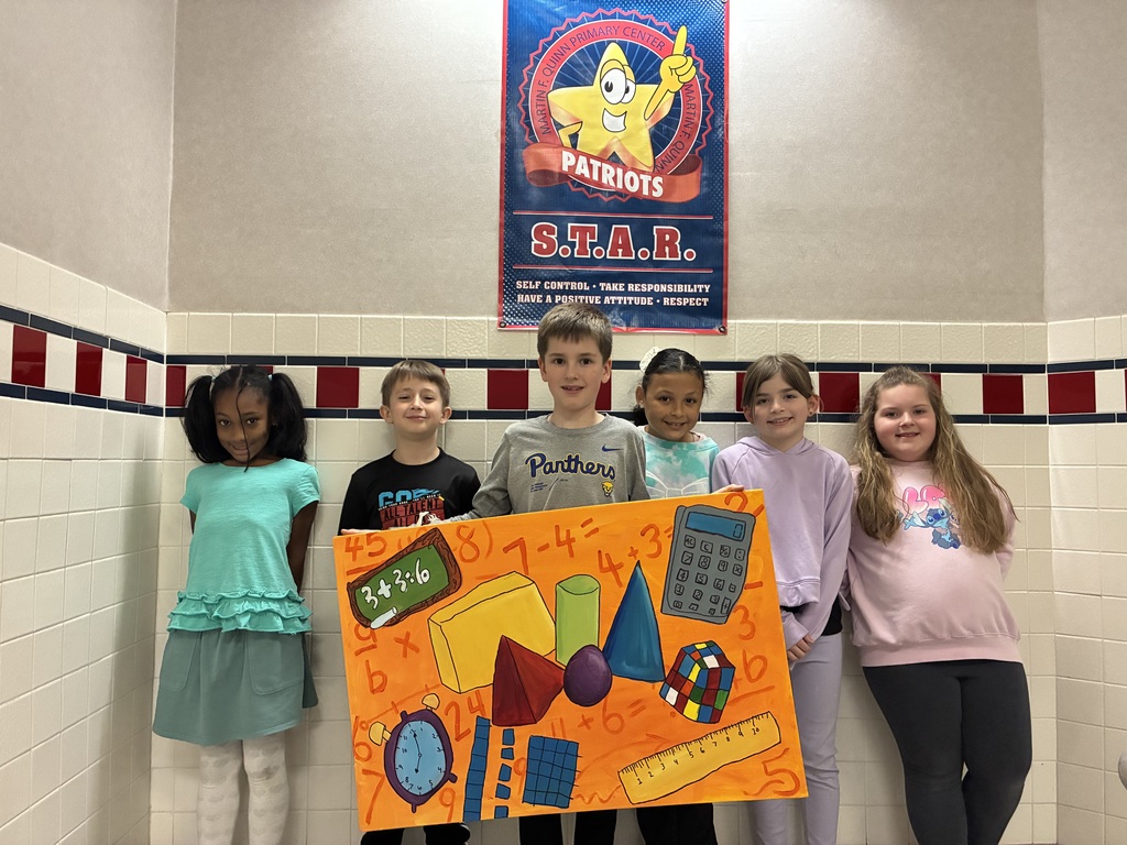 A group of students holding a canvas with school themed items