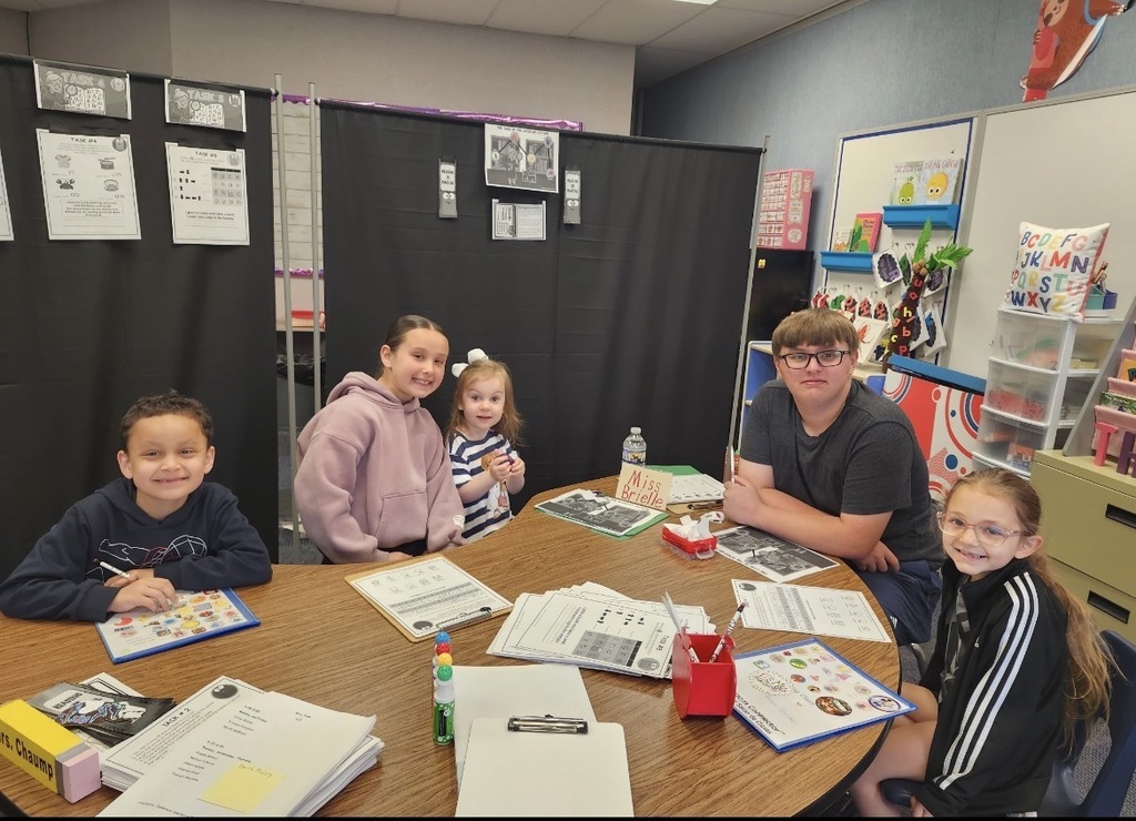 A  child working as a teacher on bring your kid to work day. 