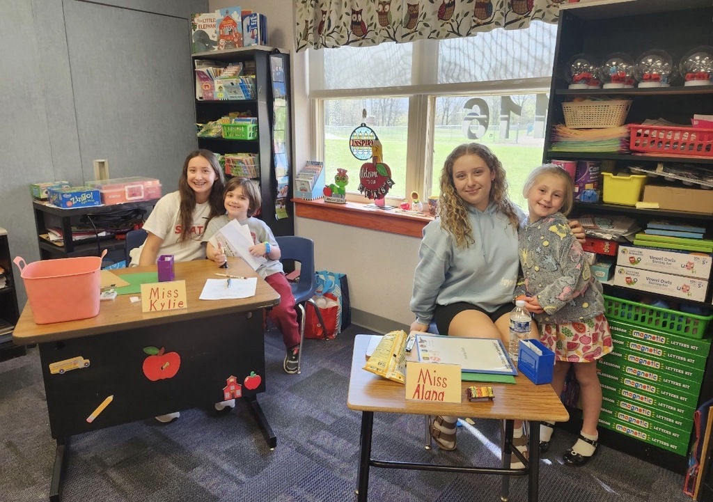 A  child working as a teacher on bring your kid to work day. 