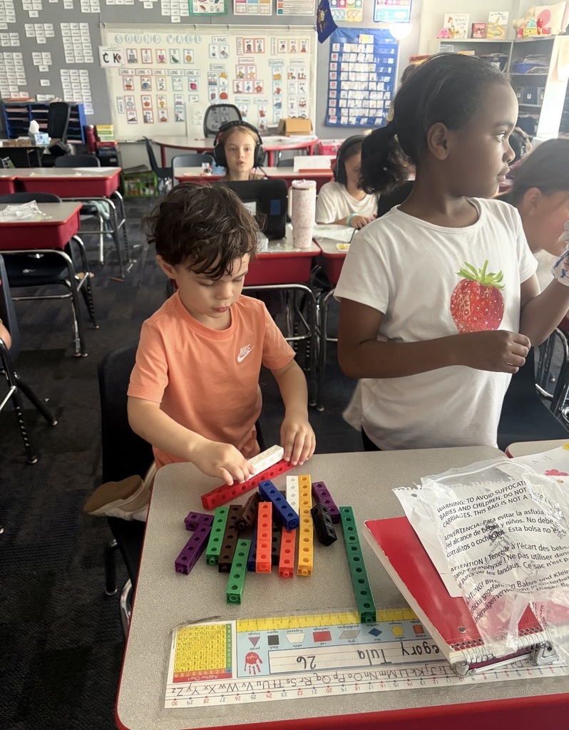 A  child working as a teacher on bring your kid to work day. 