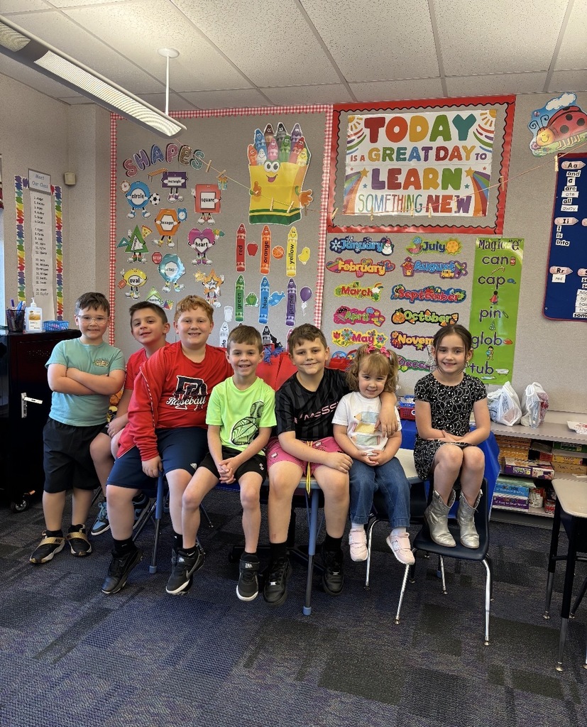A  child working as a teacher on bring your kid to work day. 