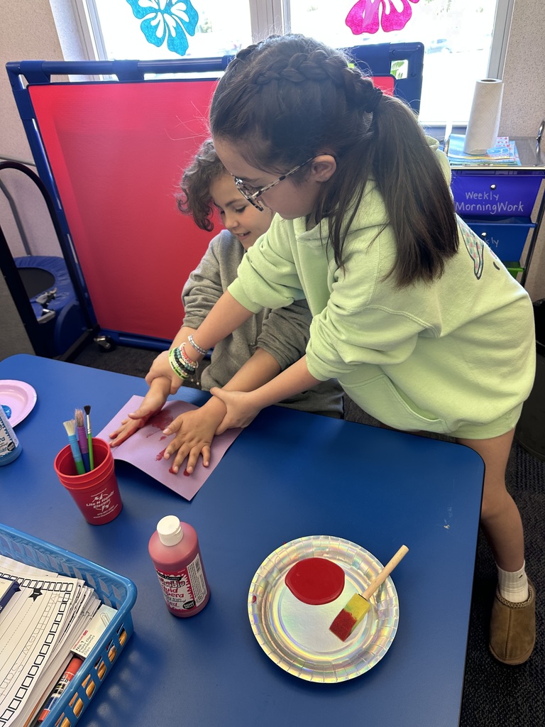 A  child working as a teacher on bring your kid to work day. 