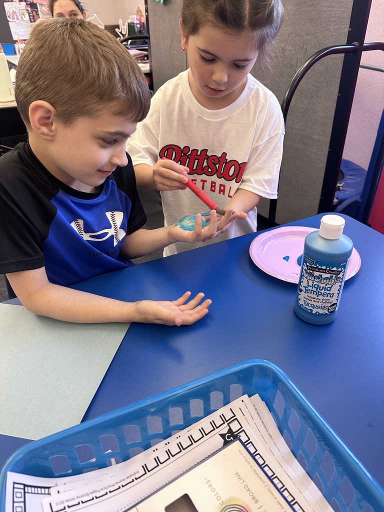 A  child working as a teacher on bring your kid to work day. 