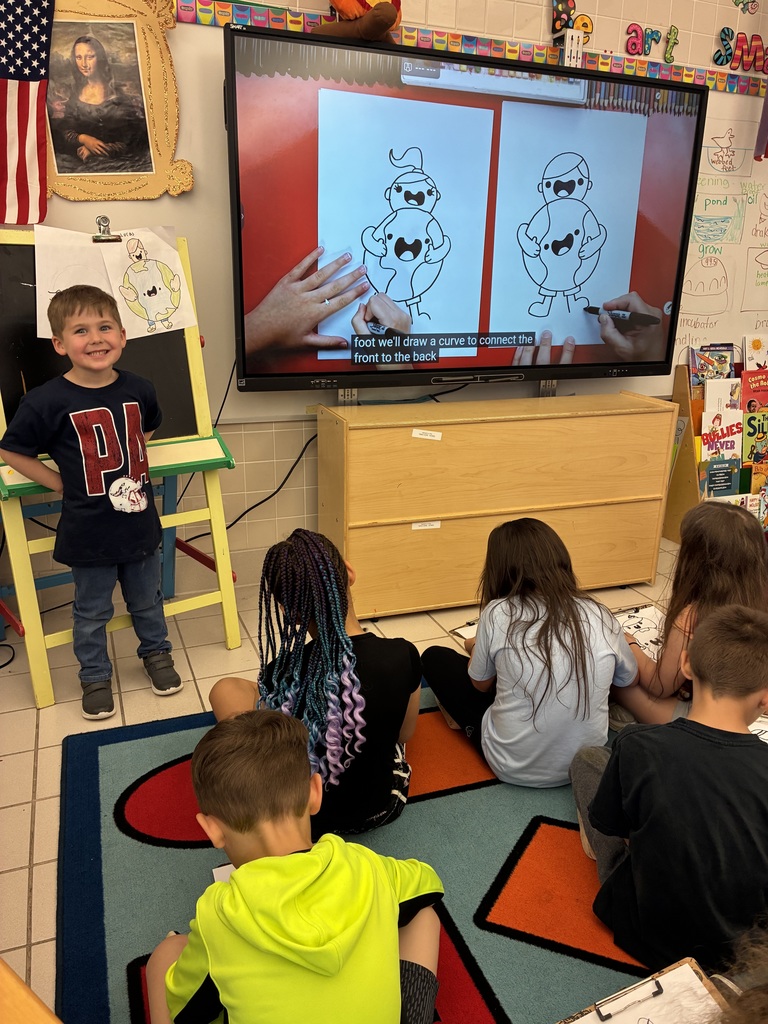 A  child working as a teacher on bring your kid to work day. 