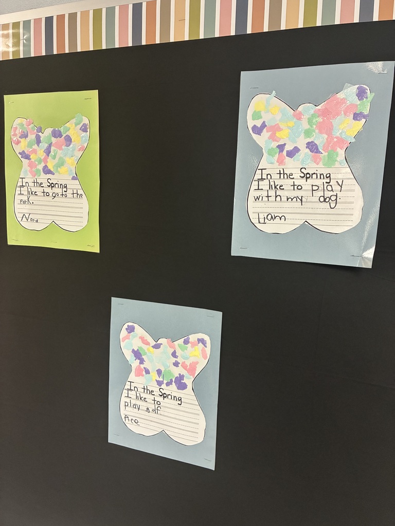 A spring bulletin board with student writing.