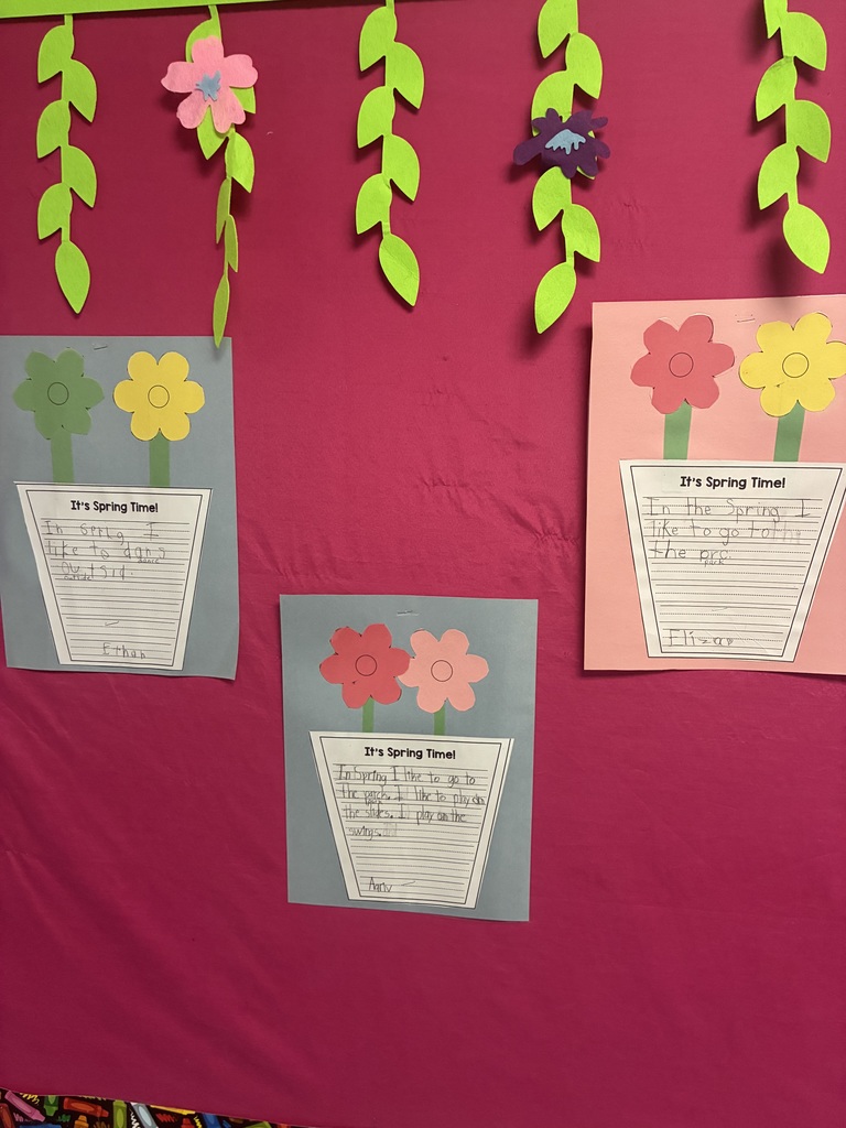 A spring bulletin board with student writing.