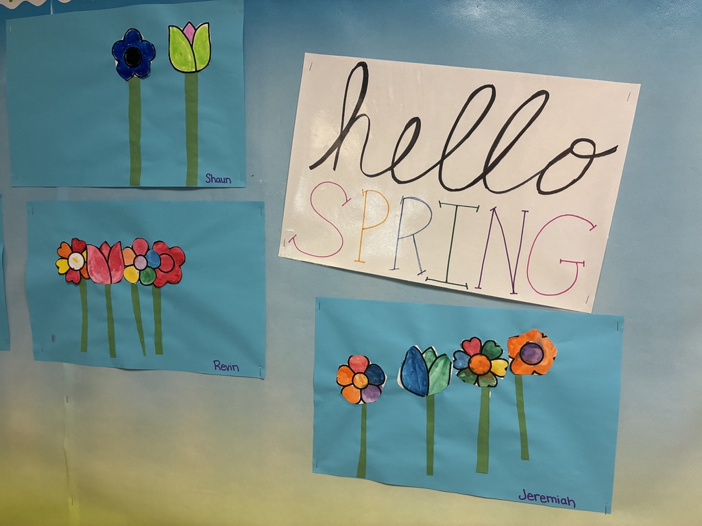 A spring bulletin board with student writing.