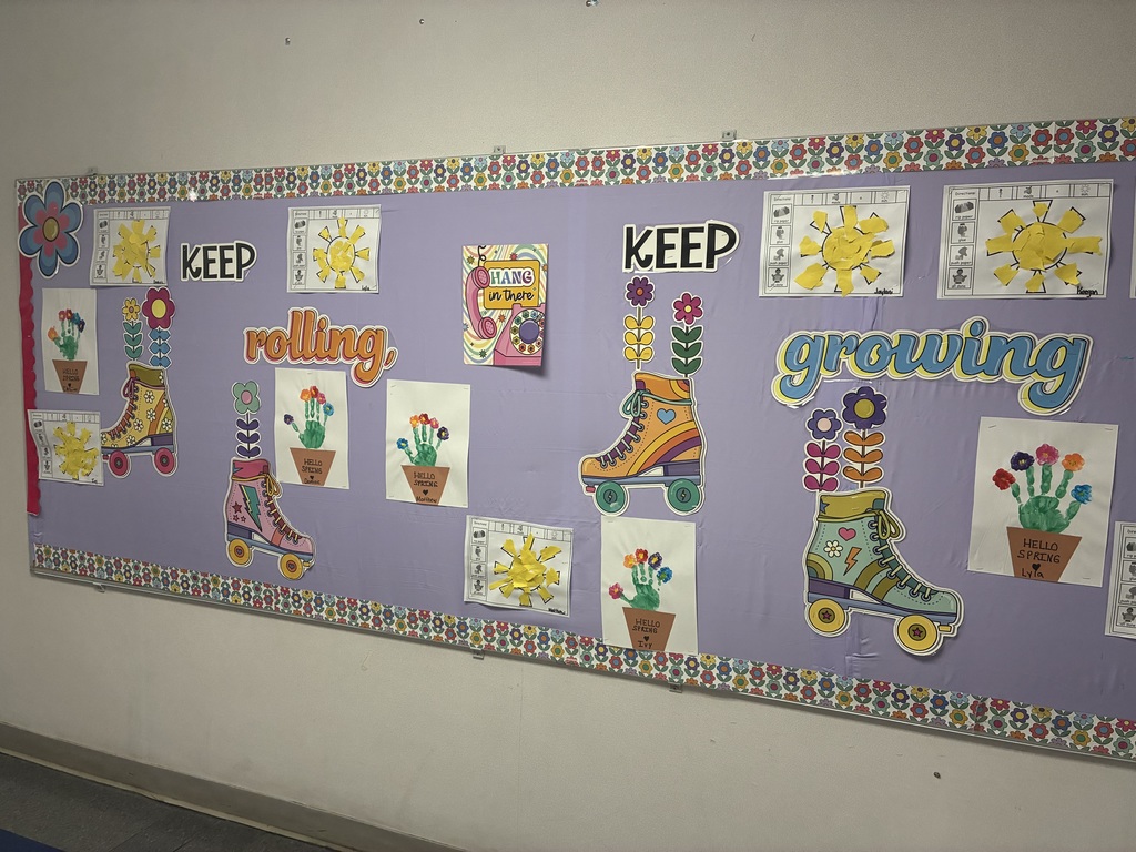 A spring bulletin board with student writing.