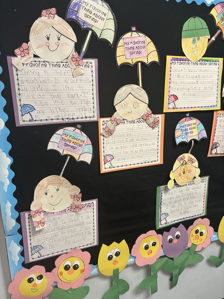 A spring bulletin board with student writing.