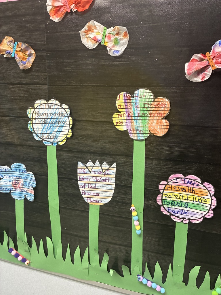 A spring bulletin board with student writing.