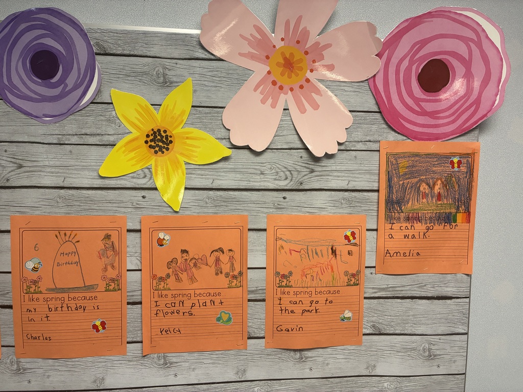 A spring bulletin board with student writing.