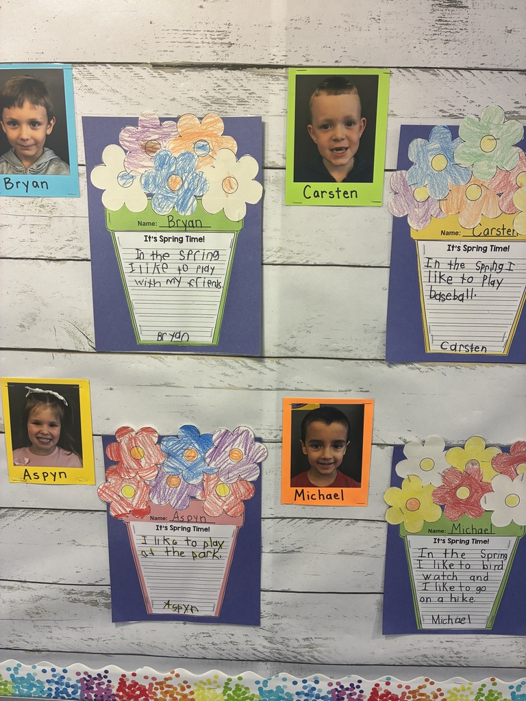 A spring bulletin board with student writing.