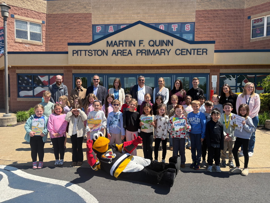 Students with penguin hockey representatives and tux mascot  