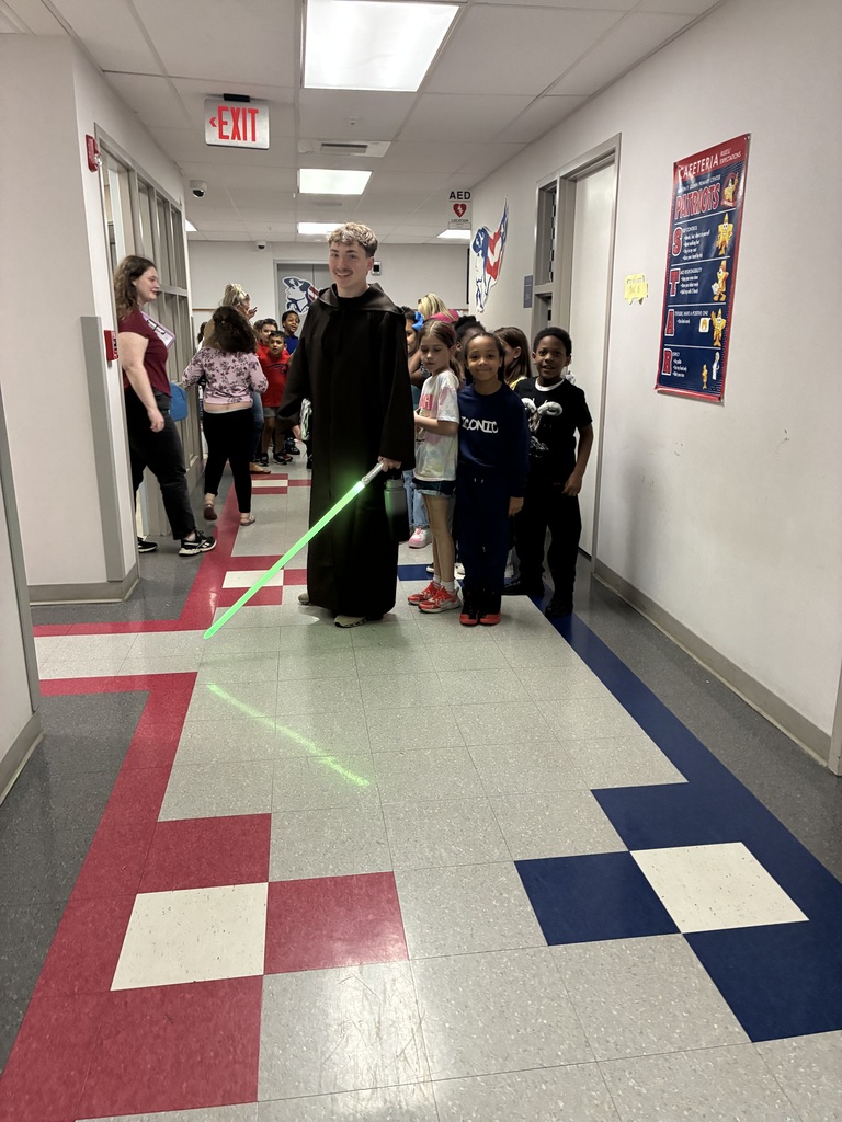 A teacher in the hallway dressed as a jedi