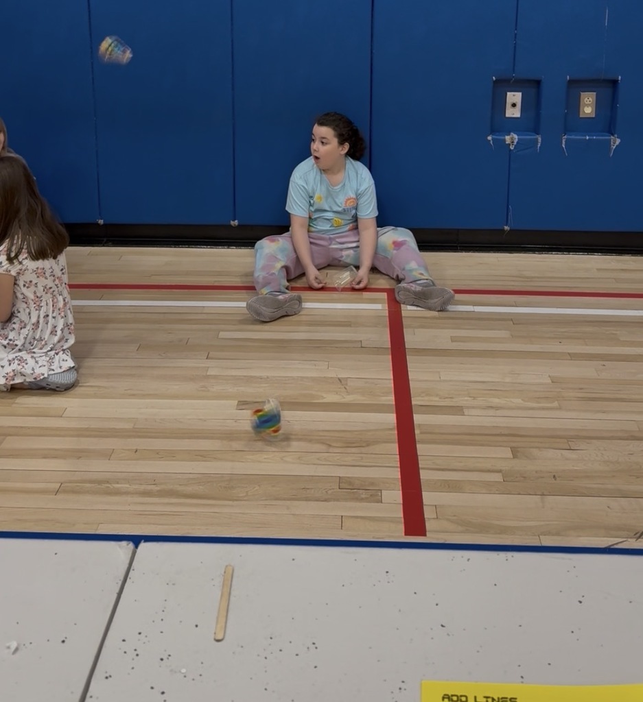 A student launching a cup rocket. 