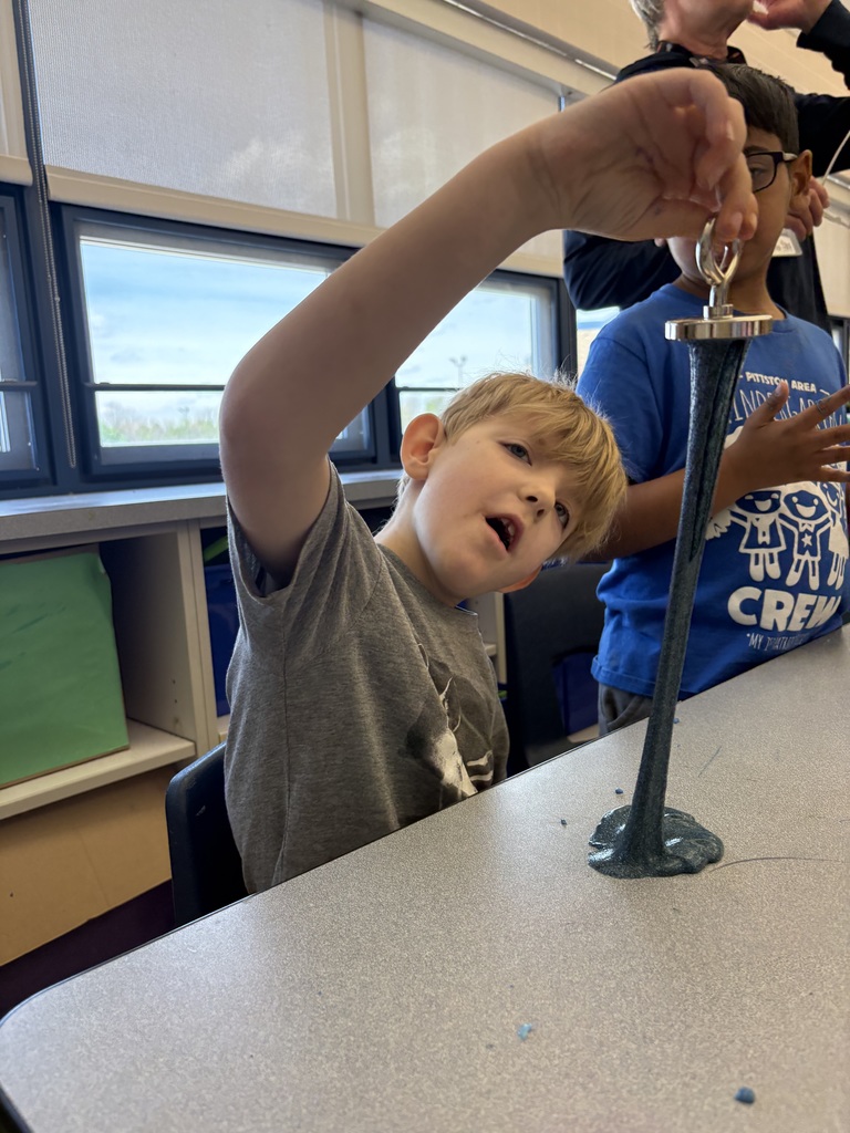 A student stretching magnetic slime. 