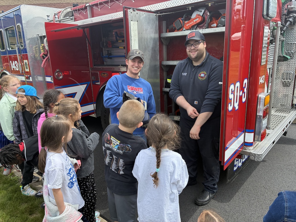 Students outside looking at a fire truck
