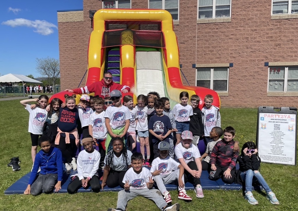 Students at field day with a bounce house. 