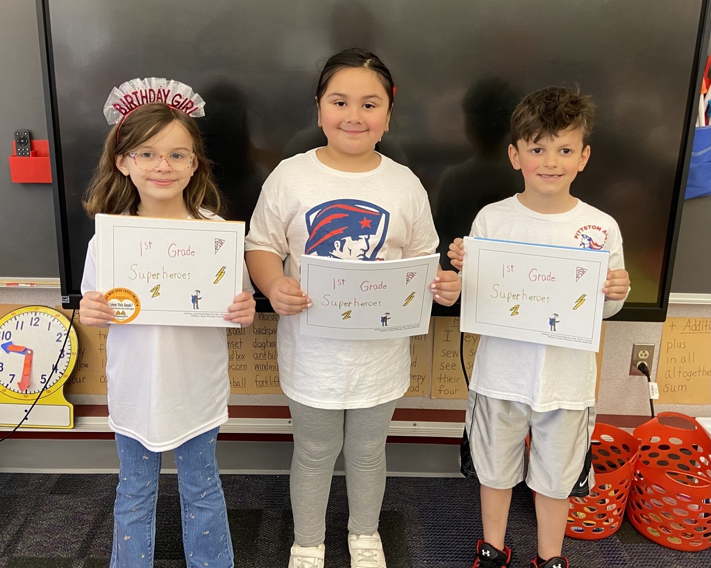 Flynn’s class holding self authored book 